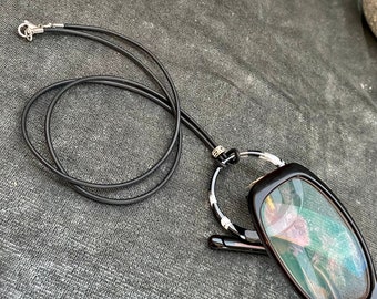 Eyeglass necklace holder. Acrylic  black and white ring pendant. Glasses  lanyard on a leather cord.