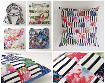 May include: A set of four pillow covers featuring a patchwork design with black and white stripes and colorful floral patterns. The pillow covers are made of fabric and have a blue backing.