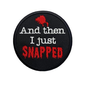 May include: Black and red embroidered patch with the text "And then I just snapped" in white and red dripping letters.
