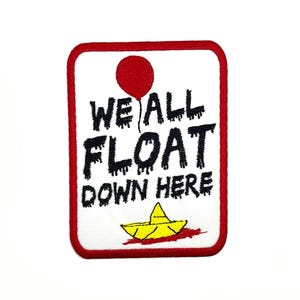 May include: Red and white embroidered patch with a red balloon and a yellow paper boat. The text on the patch reads "We All Float Down Here."