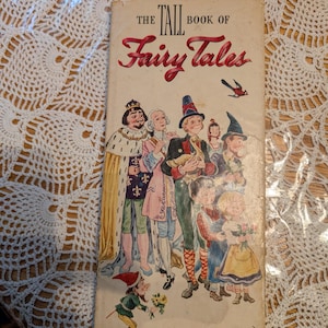 May include: A tall, rectangular vintage book titled The Tall Book of Fairy Tales with illustrations by William Sharp. The cover features a king, a prince, a person holding a goose, and children in colorful clothing. Published by Harper & Brothers.