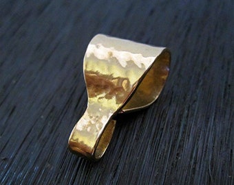 May include: A gold-toned metal pendant bail with a hammered texture. The bail is designed to attach a pendant to a chain or cord.