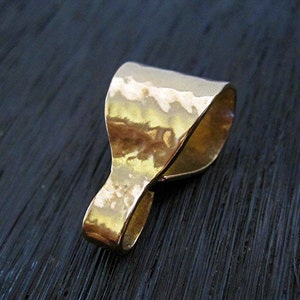 May include: Gold-toned metal pendant bail with a hammered finish. The bail is designed to attach a pendant to a chain or cord.
