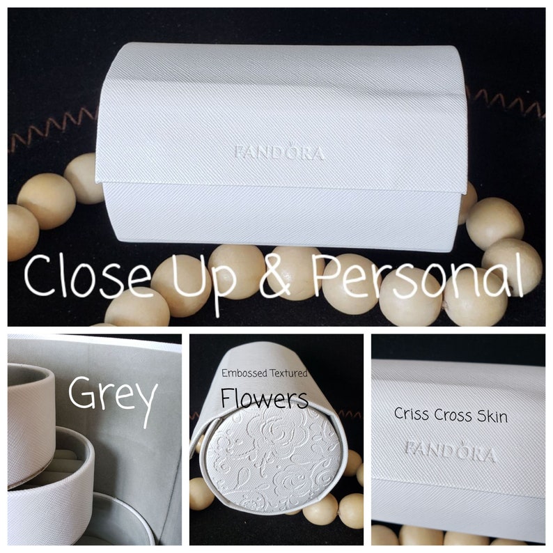 May include: Three white jewelry boxes with different textures. The top box has the word "PANDORA" embossed on the lid. The middle box has an embossed floral pattern. The bottom box has a criss-cross pattern. All three boxes are labeled with the text "PANDORA".
