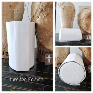 May include: White cylindrical box with the word "Pandora" printed on the side. The box is sitting on a black surface with the words "Limited Edition" printed below it.