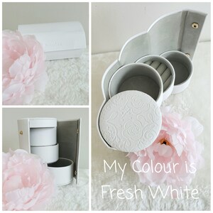 May include: White jewelry box with three compartments, one with a ring holder. The box has a floral design and the text "My Colour is Fresh White".