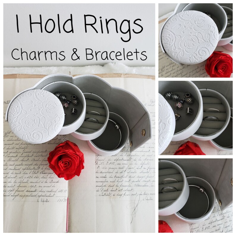 May include: White heart-shaped jewelry box with three compartments for storing rings, charms, and bracelets. The box has a white embossed design and a gold clasp.