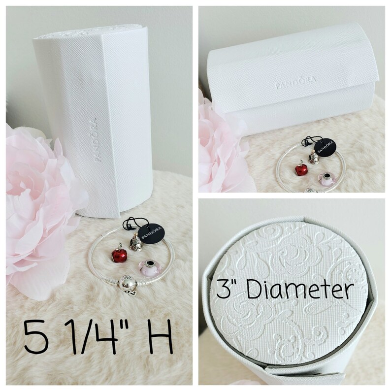 May include: White cylindrical box with the word "Pandora" printed on it. The box is 5 1/4 inches tall. A white round box with the words "3" Diameter" printed on it. A silver bracelet with red and pink charms. The bracelet is in a white box with the word "Pandora" printed on it.