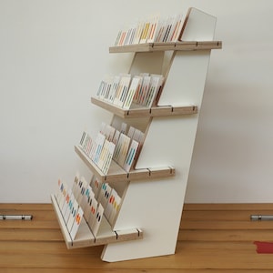 White plywood tiered display with four reversible shelves - for 75+ product cards or candles soaps – sturdy flat pack market and shop stand