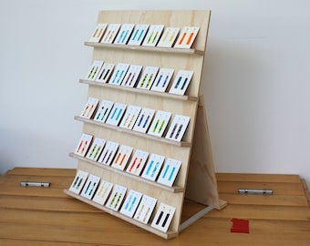 Flat-pack wooden jewellery card display for 35 product cards. Ply wood earring stand for market and shop. Folds flat. Size customisable