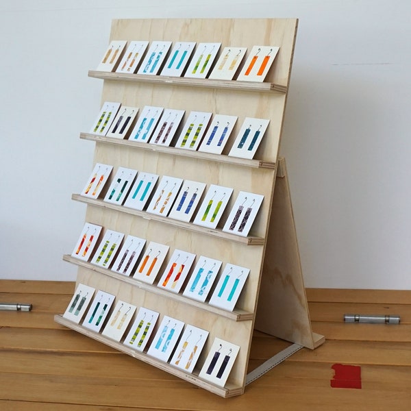 Flat-pack wooden jewellery card display for 35 product cards. Ply wood earring stand for market and shop. Folds flat. Size customisable