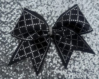 Black satin cheer bow with crystal rhinestones in a triangle patter.  Attached to a non breakable hair elastic tie.
