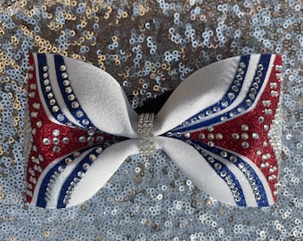 Tailless red white and royal blue cheer bow with rhinestones.
