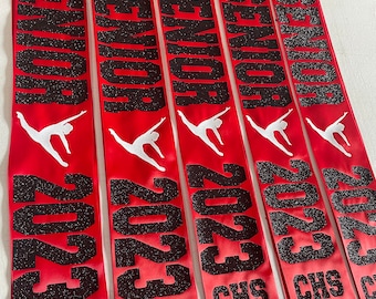 May include: Five red satin sashes with black glitter lettering. The sashes say "Senior 2023" and include the names "Blakely", "Ella", "Marien", "Caroline", and "Kailas".