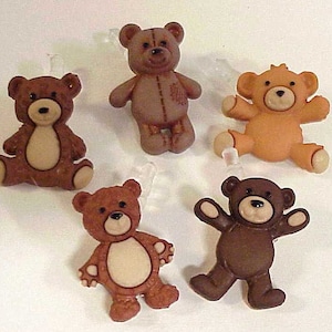 May include: Five brown teddy bear buttons with different facial expressions. The buttons are made of plastic and have a shiny finish.
