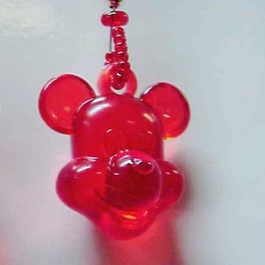 May include: A red plastic Mickey Mouse charm with a beaded chain.