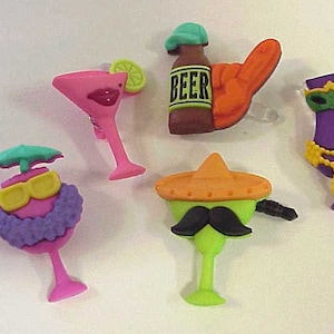 May include: Five colorful, whimsical, and fun drink charms. The charms are shaped like a margarita glass, a beer bottle, a martini glass with a sombrero, a martini glass with a purple Mardi Gras costume, and a martini glass with a purple lei.