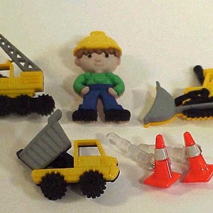 May include: A set of construction worker themed buttons featuring a yellow crane, a yellow bulldozer, a yellow dump truck, a construction worker wearing a yellow hard hat, and two orange traffic cones.