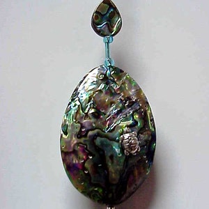 May include: A blue and green abalone shell pendant with a silver turtle charm hanging from a blue beaded chain.
