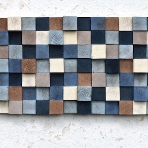 May include: A wall art piece made of wood blocks in various shades of blue, brown, and cream. The blocks are arranged in a grid pattern, creating a modern and abstract design.