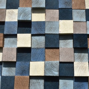 May include: A wall made of wooden squares in various shades of blue, brown, and white. The squares are arranged in a checkered pattern.