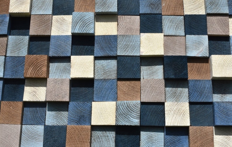 May include: A wall made of wooden squares in various shades of blue, brown, and white. The squares are arranged in a checkered pattern.