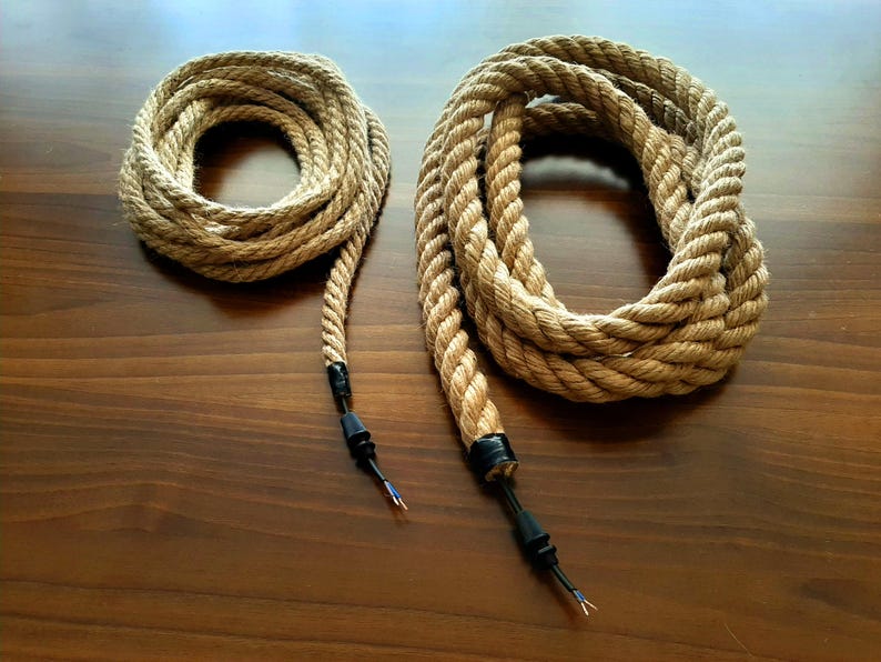 May include: Two brown rope cords with black electrical plugs. The cords are coiled and ready to be used.