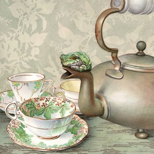 May include: A green frog sits on the spout of a silver teapot. The teapot is surrounded by three teacups, two of which are white with floral patterns and one is white with a brown and green floral pattern.