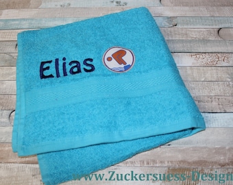 Towel with embroidery and swimming badge