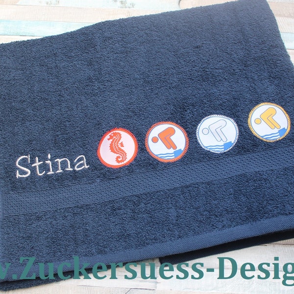 Bath towel with embroidery and swimming badges