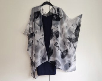 May include: A sheer black and white patterned kimono with a black sleeveless dress underneath.