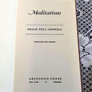 May include: The title page of a book titled Meditations by Grace Noll Crowell, with the subtitle Devotions for Women. The text is printed in black ink on an off-white page, featuring the publisher Abingdon Press, New York, and Nashville.