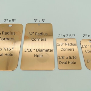 May include: Four rectangular metallic tags with rounded corners and pre-drilled holes. The tags are labeled with dimensions: 3" x 5" with 1/2" radius corners and 1/4" x 7/16" oval hole, 3" x 5" with 1/4" radius corners and 3/16" diameter hole, 2" x 3.5" with 1/8" radius corners and 1/8" x 5/16" oval hole, and 2" x 3.5" with 1/2" radius corners and 1/4" diameter hole.