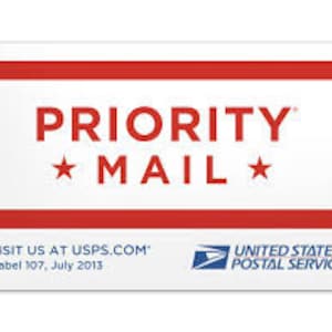 May include: A white Priority Mail label with red stripes and blue stars. The label has the text "PRIORITY MAIL" in bold, red letters. The text "VISIT US AT USPS.COM" is printed in black below the label. The label also includes the text "Label 107, July 2013" and the United States Postal Service logo.
