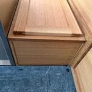 May include: A rectangular wooden storage box featuring a light brown natural wood grain finish. The box has a flat, inset lid with visible joinery at the corners and smooth, straight sides. The construction displays a clear, light-toned wood texture throughout the entire exterior surface of the container.
