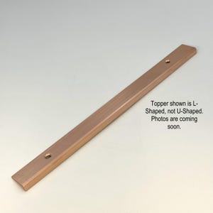 May include: A copper-colored, L-shaped metal trim piece with two pre-drilled holes. The text in the image states the trim is L-shaped, not U-shaped, and that more photos are coming soon.
