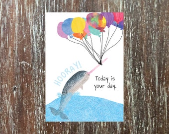 narwhal birthday card 'May all your dreams come true,' with rainbow balloons hoisting a narwhal into the sky