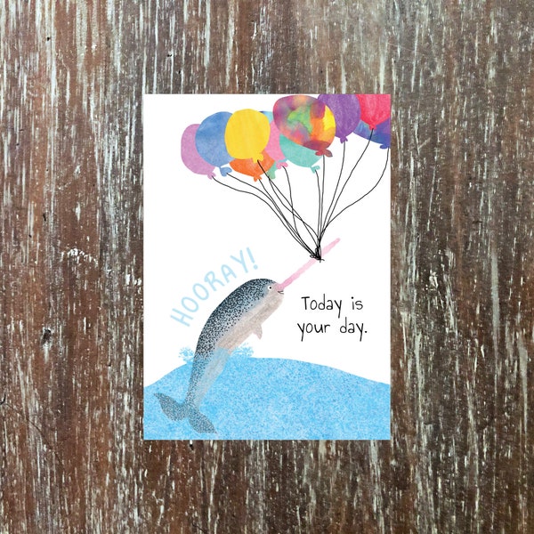 narwhal birthday card 'May all your dreams come true,' with rainbow balloons hoisting a narwhal into the sky