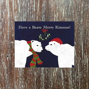Holiday greeting card with festive polar bears meeting under the mistletoe, &#39;Have a Beary Merry Kissmas!&#39;
