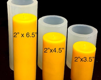 May include: Three clear silicone candle molds with yellow candles inside. The molds are labeled with the dimensions of the candles: 2" x 6.5", 2" x 4.5", and 2" x 3.5".