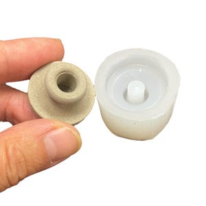 May include: A beige resin knob with a threaded hole and a white silicone mold for making the knob.