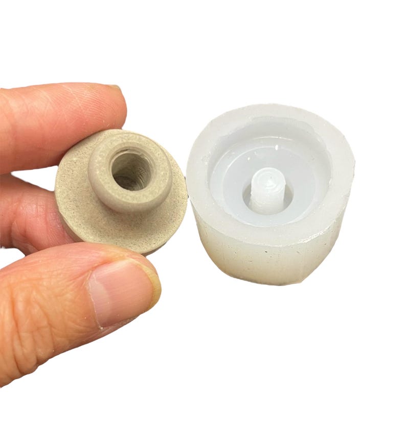 May include: A beige resin knob with a threaded hole and a white silicone mold for making the knob.