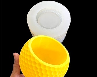 May include: A yellow, round silicone mold with a honeycomb pattern. The mold is designed to create a decorative planter or bowl.
