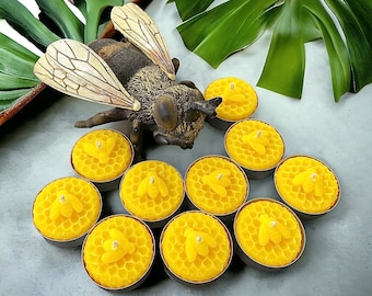May include: A set of nine yellow beeswax candles shaped like honeycombs with a bee design in the center. The candles are arranged in a circle around a small, brown, ceramic bee figurine.