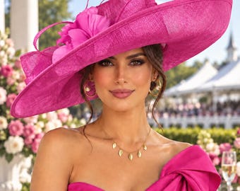 May include: A wide-brimmed fuchsia hat featuring a textured woven material, adorned with a large fabric flower and thin, curved decorative accents on the side. The hat has a structured crown and a broad, slightly upturned brim in a vibrant pink.