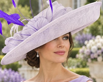 May include: A wide-brimmed lavender hat featuring a structured crown and a large, layered fabric flower accent. The hat is adorned with several vibrant purple feathers extending upwards and outwards, creating a decorative and textured appearance.