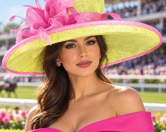 May include: A wide-brimmed hat featuring a bright lime green crown and brim with a vibrant pink trim along the edge. The hat is adorned with a large, elaborate pink floral arrangement made of stiffened fabric and feathers on the left side.