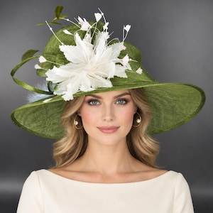 May include: A wide-brimmed olive green hat featuring a textured woven finish. The hat is adorned with a large, white, multi-layered floral embellishment made of delicate feathers and thin stems topped with small, pale pink accents.