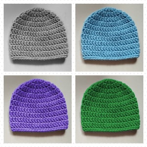 May include: Four crocheted hats in different colors: gray, light blue, purple, and green. The hats are all the same style, with a simple, rounded shape.