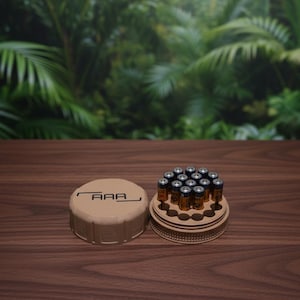 May include: A white ceramic mug with a black handle and the text "But First, Coffee" in a black, handwritten-style font. The mug is on a white surface.